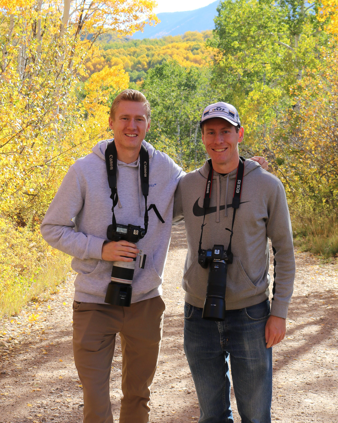Spencer and Jonathan Free on an autumn trail with their cameras